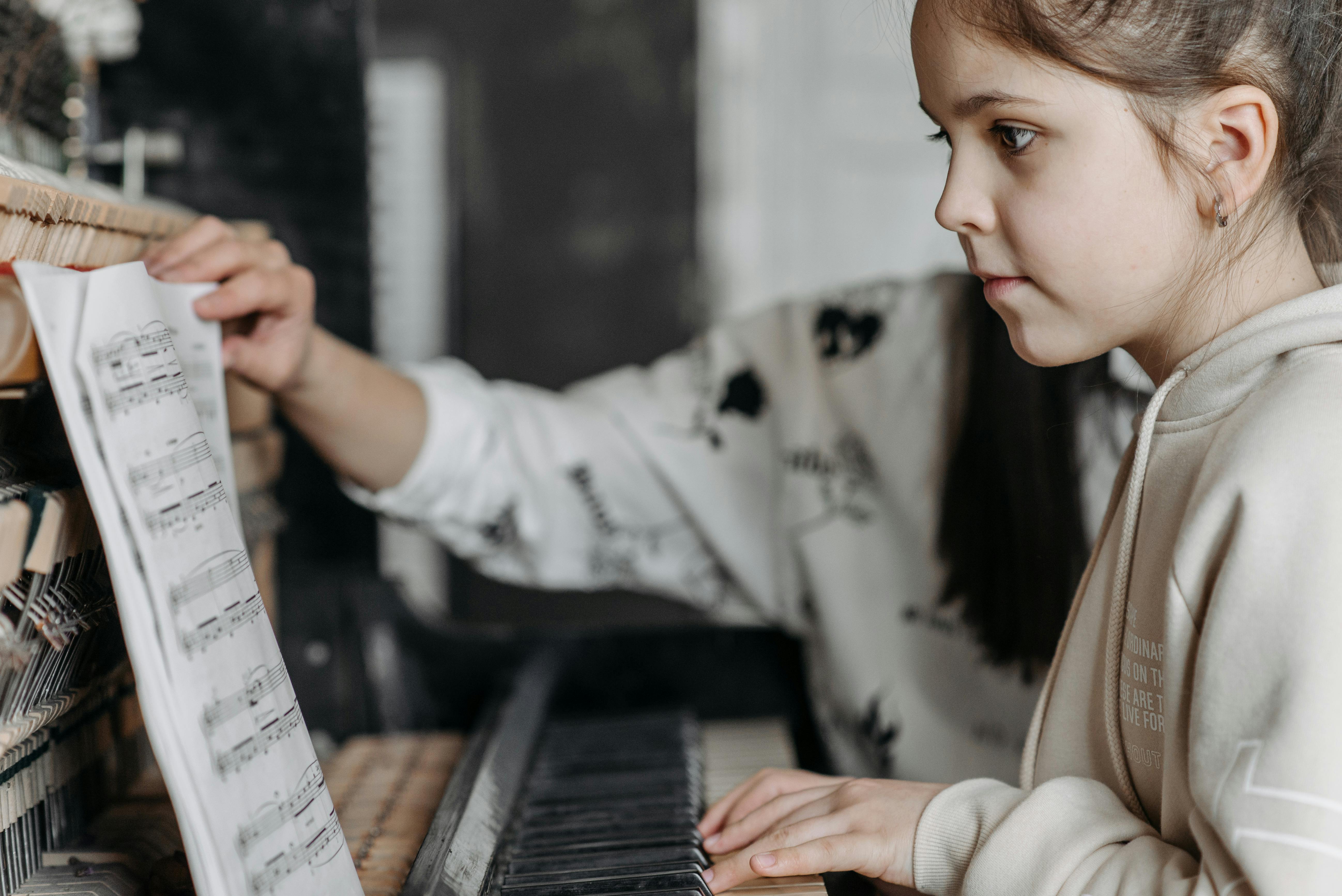 Young girl taking a piano lesson